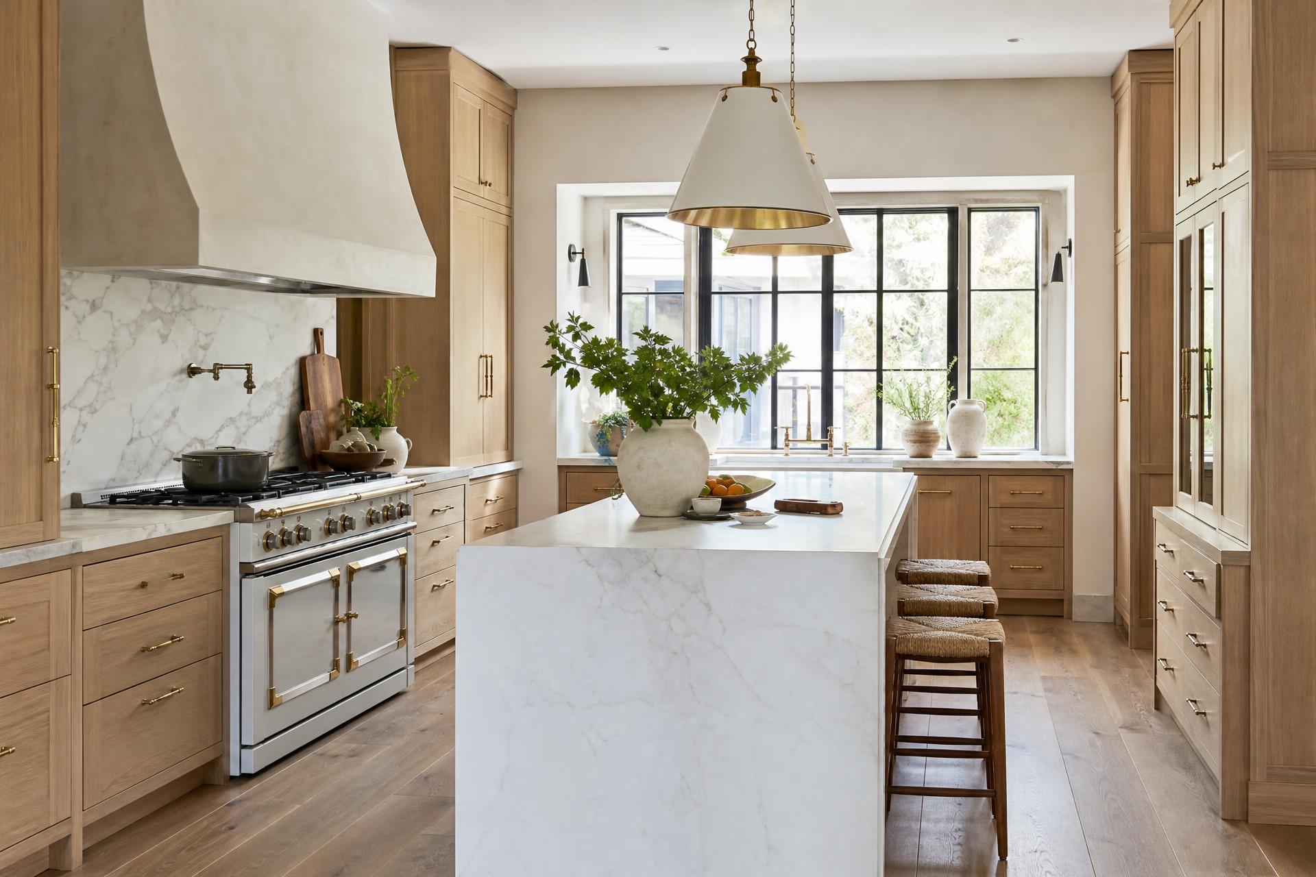 Custom designer kitchen with white oak cabinetry and marble island